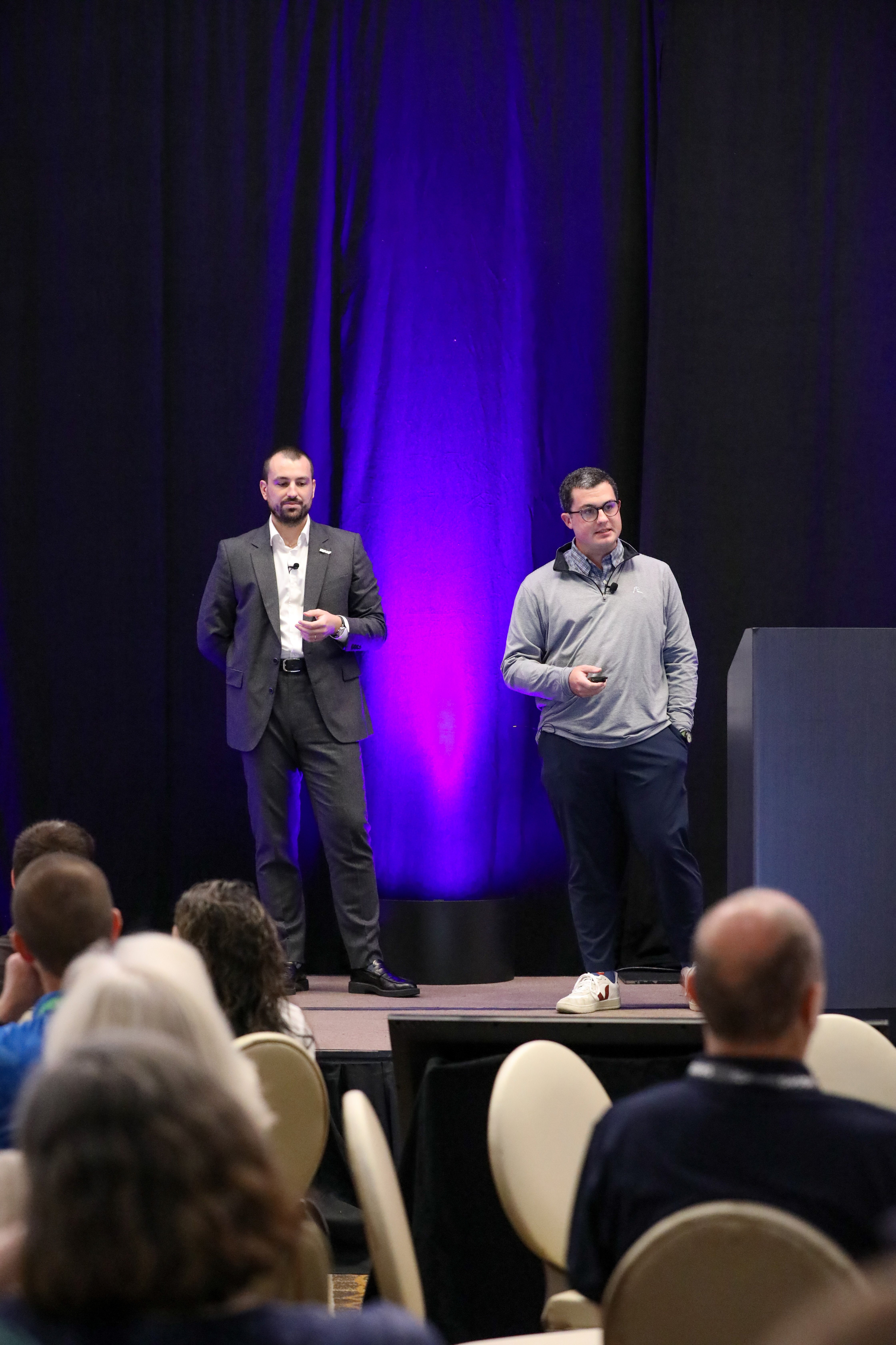 ダラスで開催されたIQGeo Americas Meetup 2025のステージで発表するIQGeoのトーマス・トゥイリエとマット・ロバーツ。